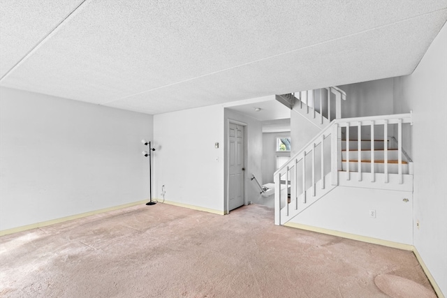 unfurnished room with carpet flooring and a textured ceiling