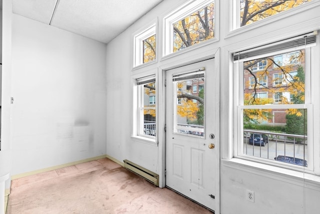 entryway featuring baseboard heating and light carpet