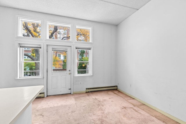 interior space featuring light colored carpet, a baseboard radiator, and a textured ceiling