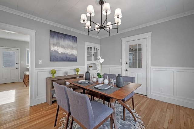 dining room featuring crown molding, a chandelier, and light hardwood / wood-style floors