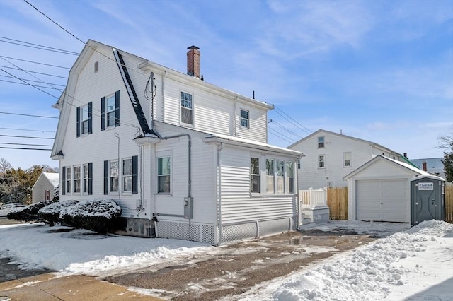 view of front facade featuring a garage and an outdoor structure