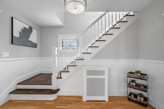 stairway with hardwood / wood-style floors