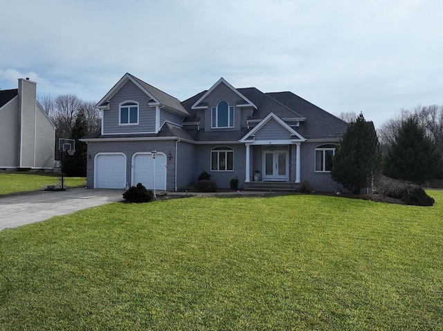 view of front of house with french doors, brick siding, concrete driveway, a garage, and a front lawn