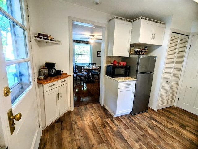 40 Ayer Rd, Shirley, MA 01464 - kitchen featuring freestanding refrigerator, black microwave, dark wood-style flooring, ornamental molding, and white cabinetry