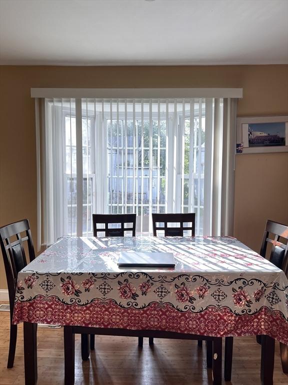 1 Coburn Ct, Lowell, MA 01854 - dining space with healthy amount of natural light and wood finished floors