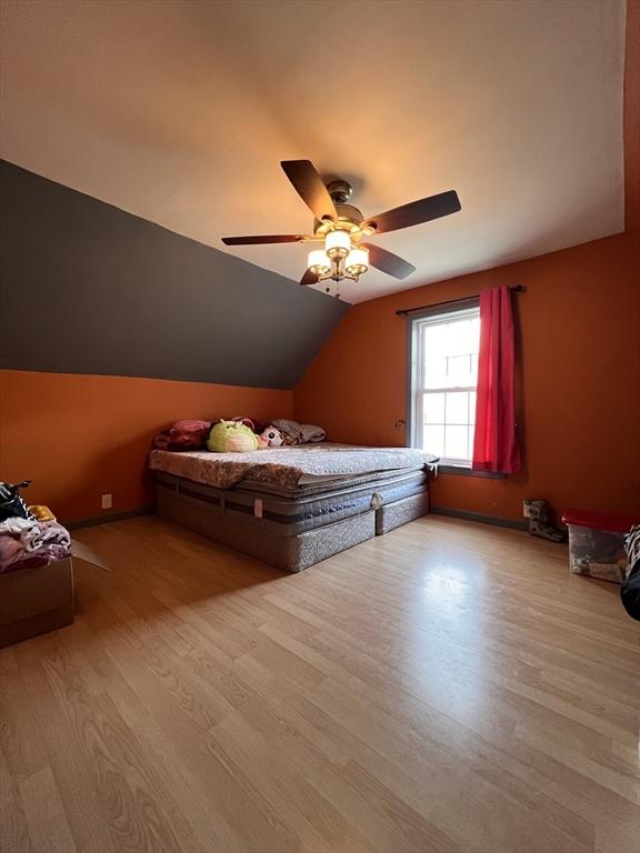 1 Coburn Ct, Lowell, MA 01854 - bedroom with wood finished floors, vaulted ceiling, and a ceiling fan