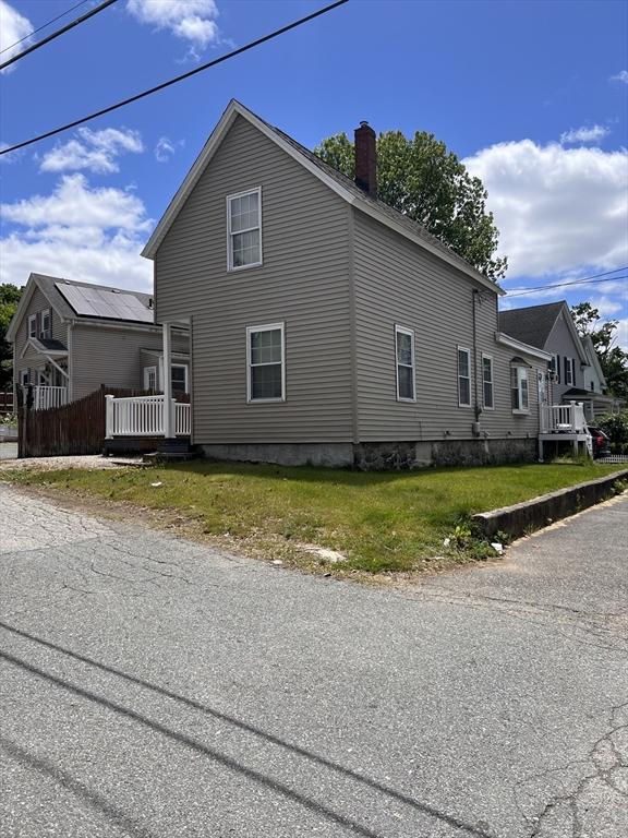 1 Coburn Ct, Lowell, MA 01854 - view of property exterior with a chimney and a yard