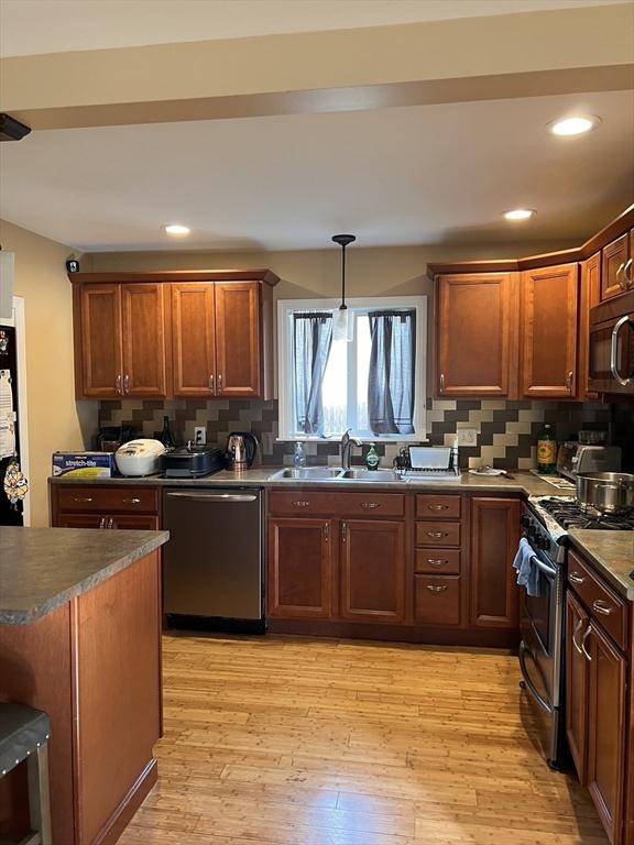1 Coburn Ct, Lowell, MA 01854 - kitchen featuring stainless steel appliances, a sink, dark countertops, tasteful backsplash, and recessed lighting