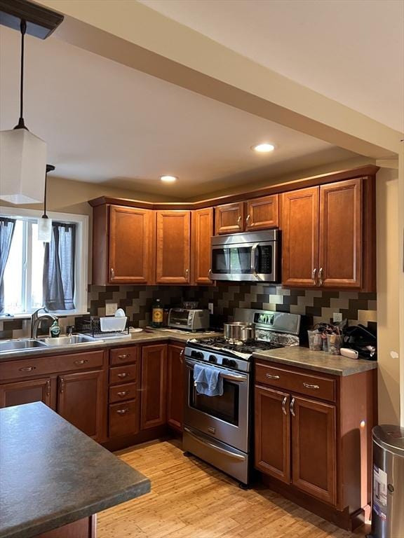 1 Coburn Ct, Lowell, MA 01854 - kitchen with stainless steel appliances, a sink, dark countertops, light wood-style flooring, and recessed lighting