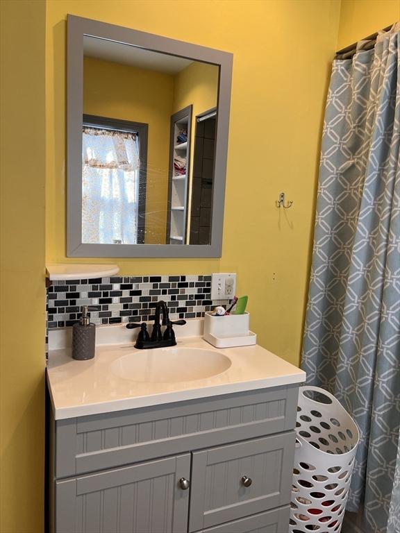 1 Coburn Ct, Lowell, MA 01854 - full bath featuring vanity and backsplash