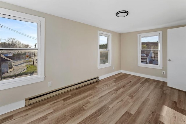 32 Worcester Rd, Charlton, MA 01507 - spare room with baseboard heating, wood finished floors, and baseboards