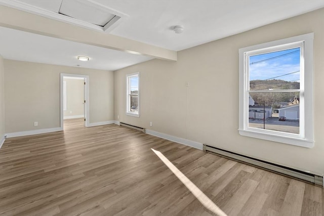 32 Worcester Rd, Charlton, MA 01507 - unfurnished room with a baseboard radiator, light wood-style floors, and attic access