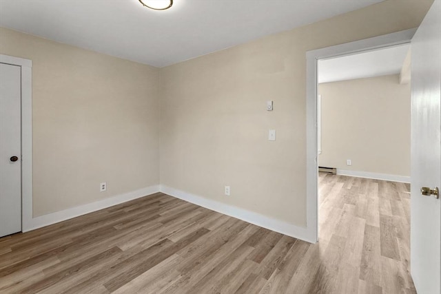 32 Worcester Rd, Charlton, MA 01507 - empty room with wood finished floors, a baseboard radiator, and baseboards