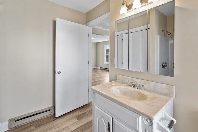 32 Worcester Rd, Charlton, MA 01507 - full bath with vanity, wood finished floors, a shower, and a baseboard radiator