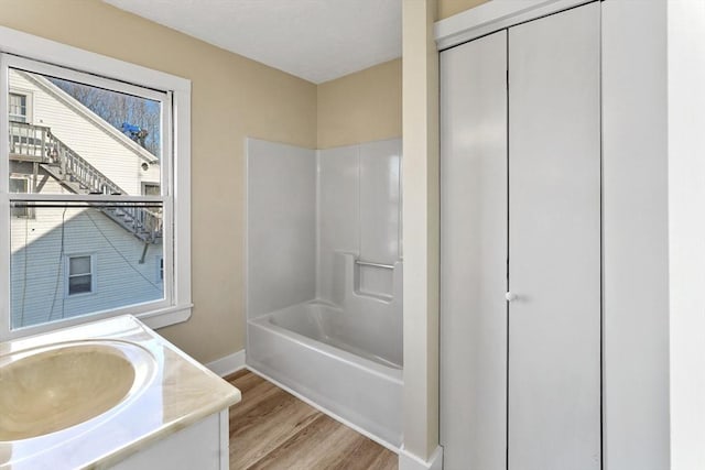 32 Worcester Rd, Charlton, MA 01507 - bathroom featuring wood finished floors, vanity, baseboards, and shower / tub combination