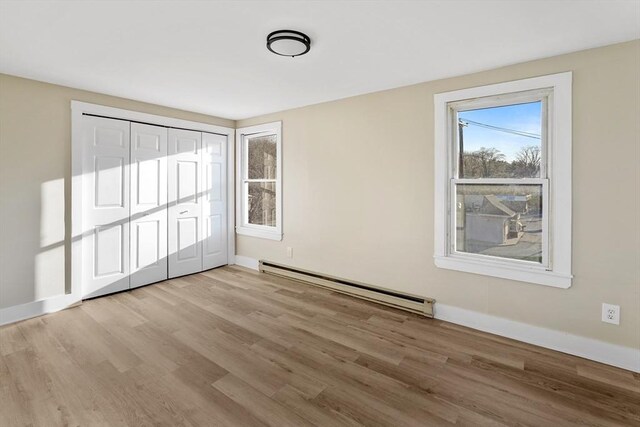 32 Worcester Rd, Charlton, MA 01507 - unfurnished room featuring a baseboard heating unit, wood finished floors, and baseboards