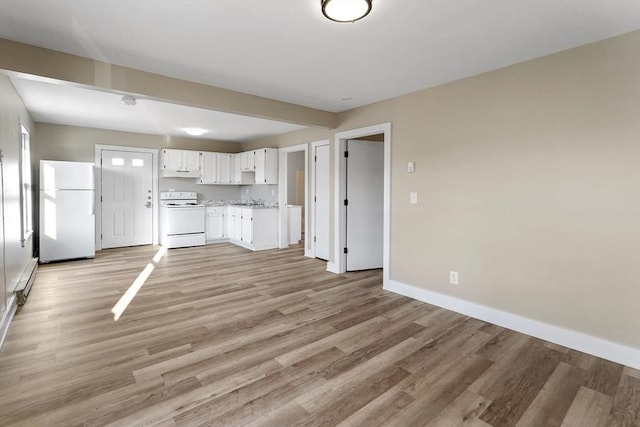32 Worcester Rd, Charlton, MA 01507 - kitchen featuring white appliances, white cabinets, light wood finished floors, baseboards, and under cabinet range hood