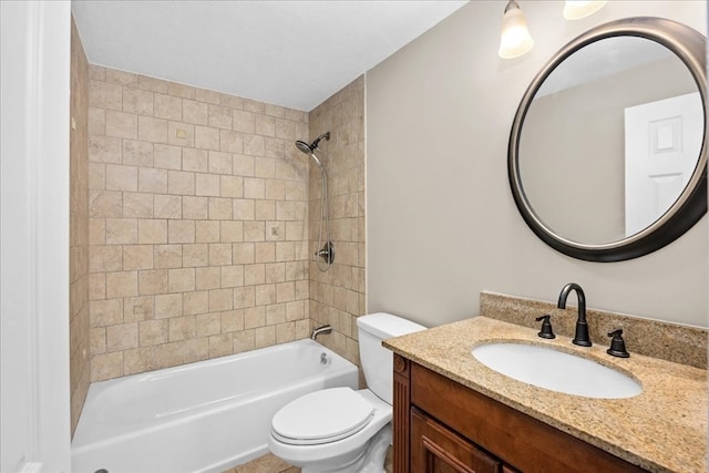 full bathroom with vanity, toilet, and tiled shower / bath