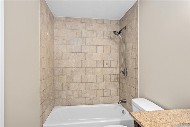 full bathroom featuring tiled shower / bath combo, vanity, and toilet