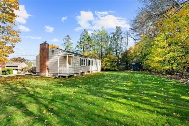 view of side of home with a yard