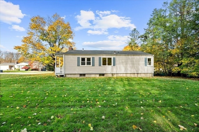 back of property featuring a lawn