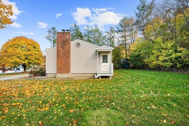 view of side of home with a lawn