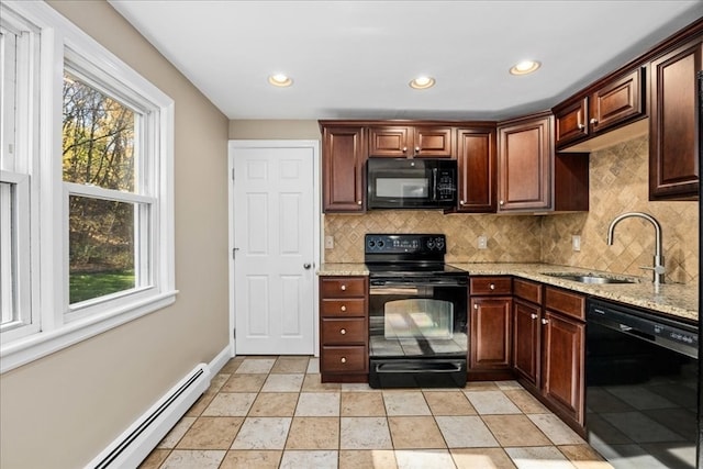 kitchen with a baseboard radiator, light stone countertops, black appliances, decorative backsplash, and sink