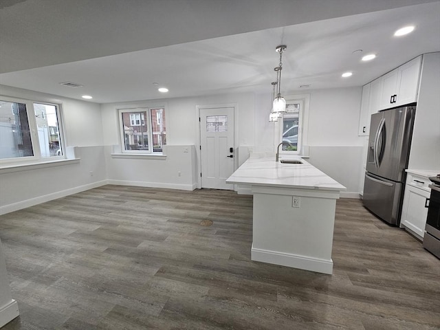 kitchen with stainless steel refrigerator with ice dispenser, decorative light fixtures, dark hardwood / wood-style flooring, and white cabinets