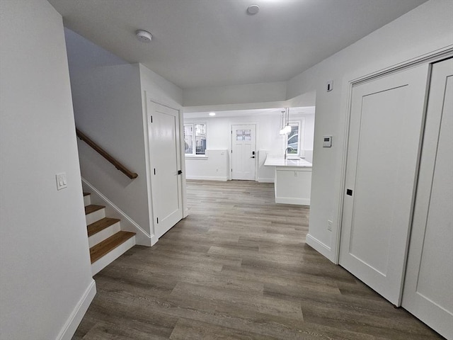 corridor with sink and light hardwood / wood-style floors