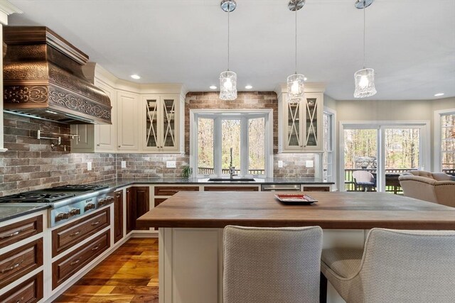 116 Coburn Rd, Berlin, MA 01503 - kitchen featuring appliances with stainless steel finishes, a sink, wood counters, decorative backsplash, and custom range hood