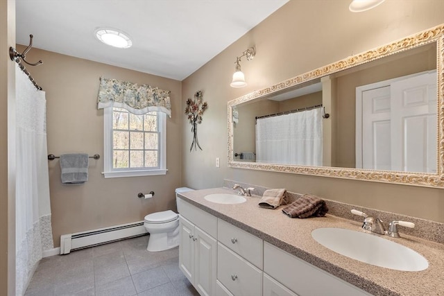 bathroom with a sink, tile patterned floors, a baseboard heating unit, and toilet
