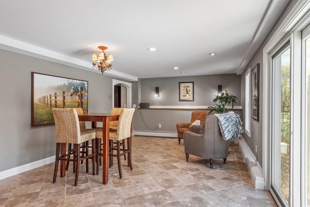 dining space featuring stone finish flooring, baseboards, a baseboard radiator, a notable chandelier, and recessed lighting