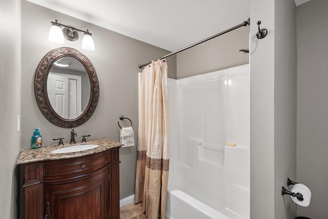 bathroom with vanity, shower / tub combo with curtain, and baseboards