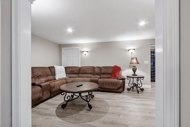 living area featuring baseboards, recessed lighting, and wood finished floors