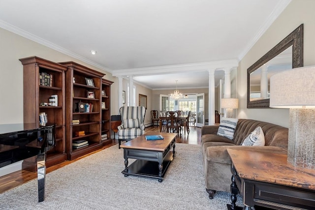 116 Coburn Rd, Berlin, MA 01503 - living area with crown molding, decorative columns, wood finished floors, and an inviting chandelier