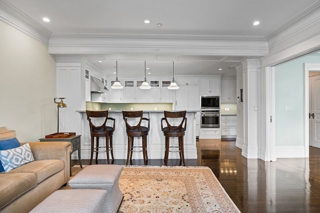 kitchen featuring white cabinets, dark wood-type flooring, hanging light fixtures, and backsplash