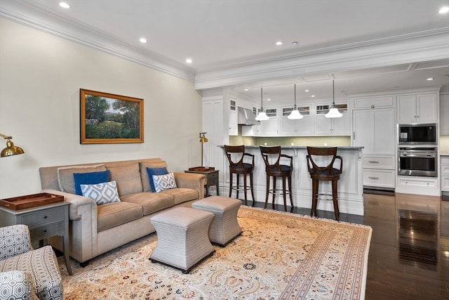 living room featuring hardwood / wood-style flooring and ornamental molding