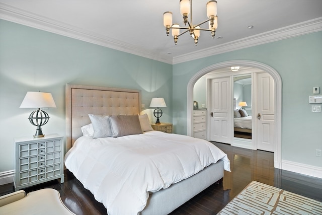 bedroom featuring a notable chandelier, ornamental molding, and dark hardwood / wood-style floors