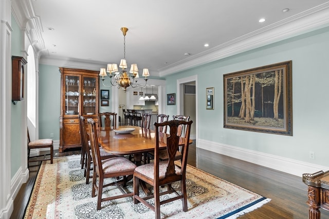 dining room featuring a notable chandelier, dark hardwood / wood-style floors, and crown molding