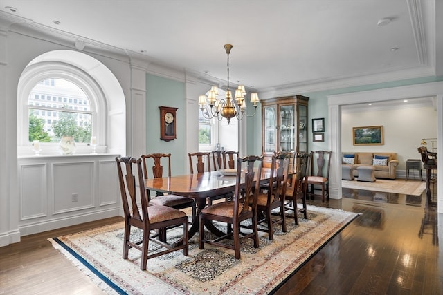 dining room with wood-type flooring and an inviting chandelier