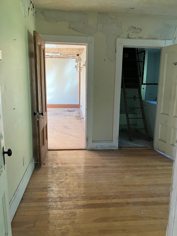 hallway with light hardwood / wood-style flooring