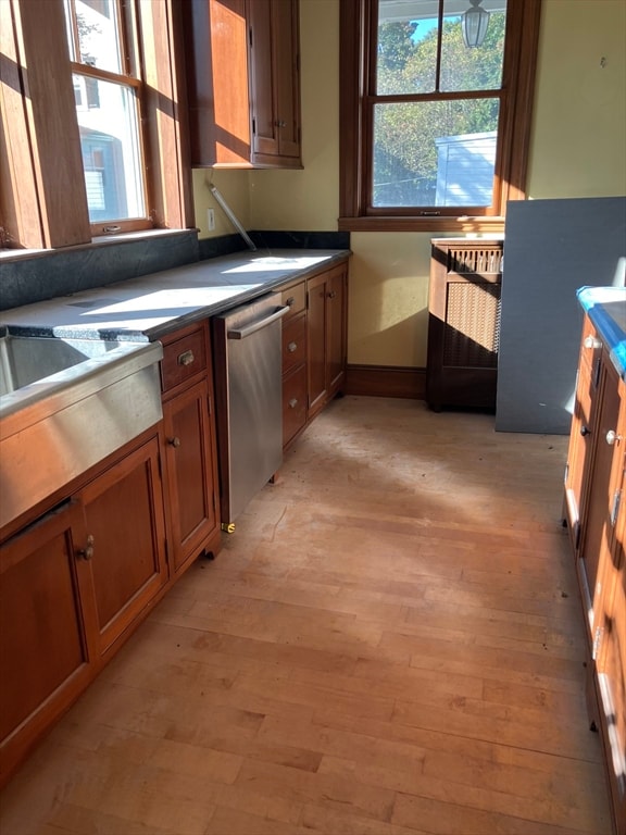 kitchen featuring light wood-type flooring and stainless steel dishwasher