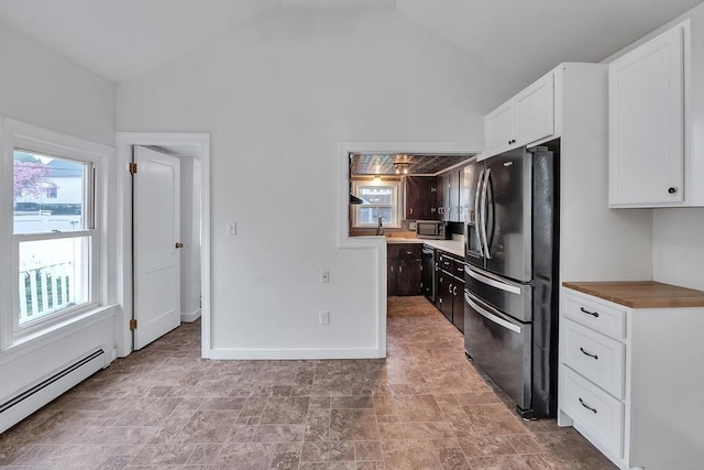 kitchen featuring stainless steel appliances, a baseboard heating unit, white cabinetry, high vaulted ceiling, and stone finish floors