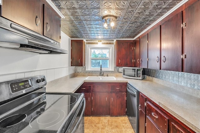 kitchen with appliances with stainless steel finishes, a sink, an ornate ceiling, under cabinet range hood, and reddish brown cabinets