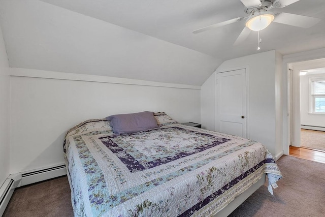 carpeted bedroom with a baseboard heating unit, vaulted ceiling, and a ceiling fan