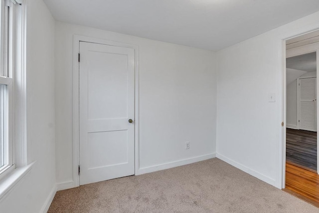 unfurnished bedroom with carpet and baseboards