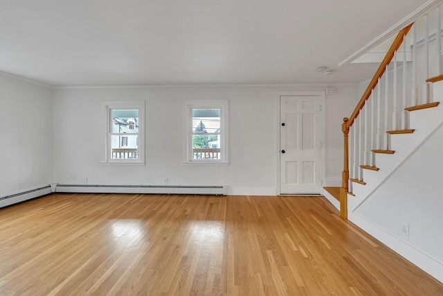 foyer featuring light wood finished floors, stairway, ornamental molding, and baseboards
