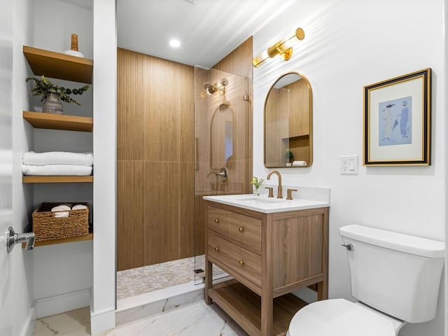 bathroom featuring toilet, a tile shower, and vanity