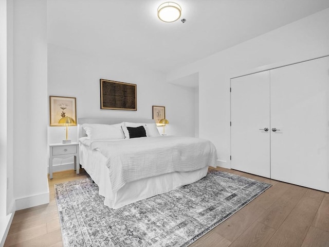 bedroom featuring light hardwood / wood-style flooring and a closet