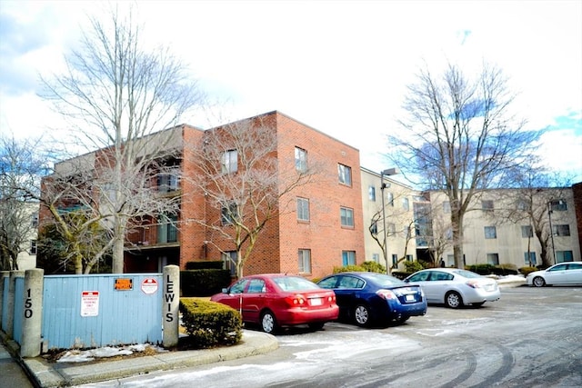 view of building exterior with uncovered parking